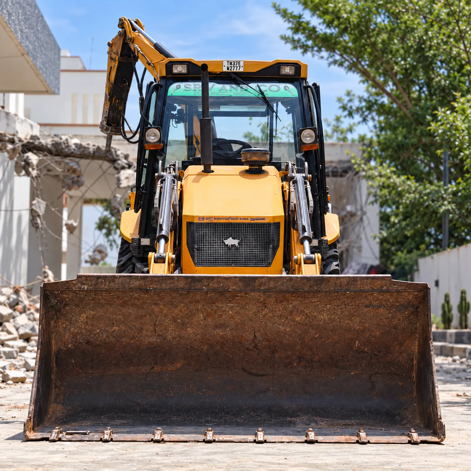 SRV AND CO backhoe loader viewed from the front in the yard